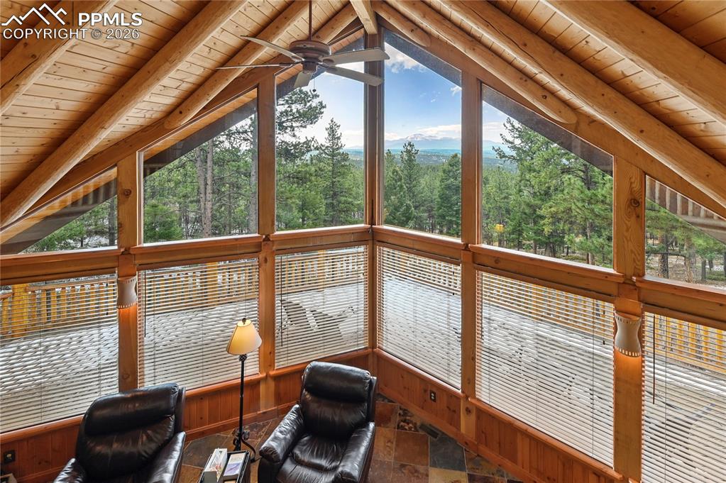 3613 Trail Creek Road Florissant, CO 80816 - Photo 29 of 43 a view of a living room with furniture and floor to ceiling windows