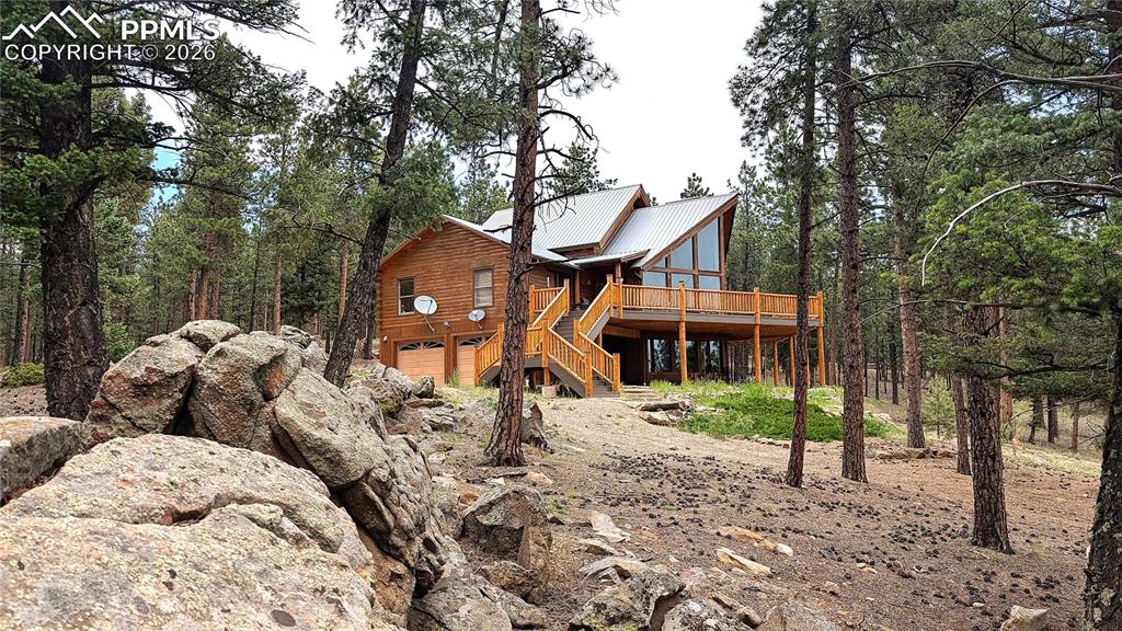 3613 Trail Creek Road Florissant, CO 80816 - Photo 3 of 43 a front view of a house with a yard