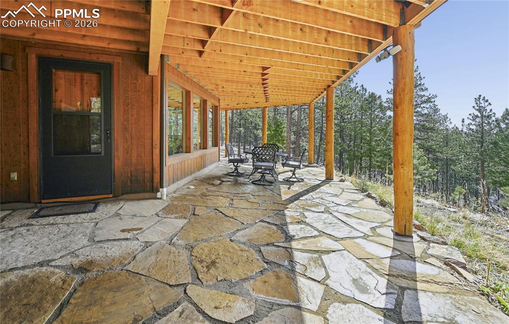 3613 Trail Creek Road Florissant, CO 80816 - Photo 33 of 43 a view of a patio with table and chairs and wooden floor