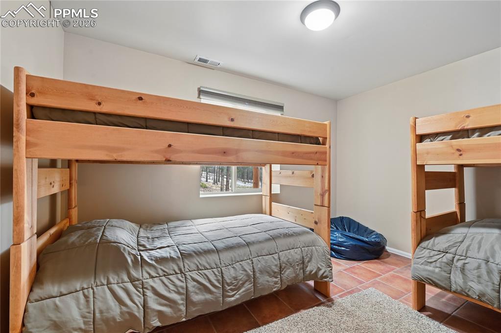 3613 Trail Creek Road Florissant, CO 80816 - Photo 35 of 43 a bedroom with a bed and window
