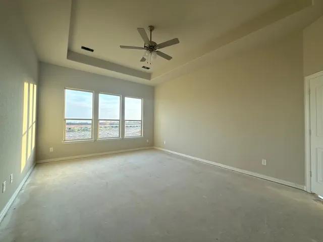 an empty room with a empty space and windows