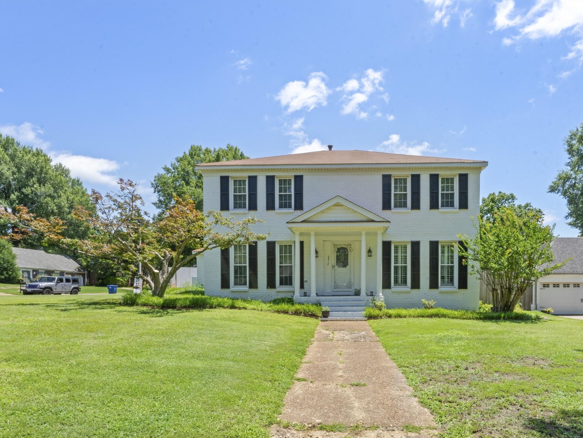 Timeless two-story painted brick home situated on a spacious corner lot in the heart of Germantown. Classic columns, mature landscaping, and exceptional curb appeal create a warm and inviting first impression.