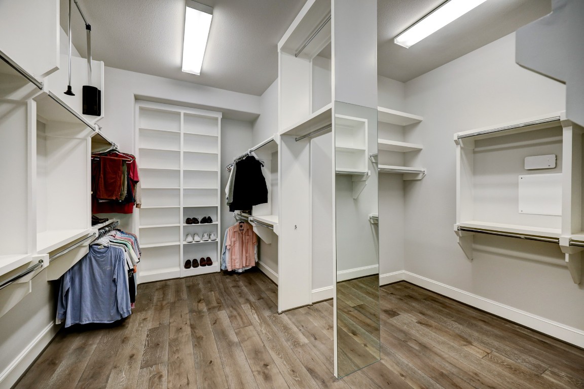 6103 Alexandra Grove Place Houston, TX 77055 - Photo 11 of 19 Primary walk-in closet with shoe shelving, hanging racks and mirrors