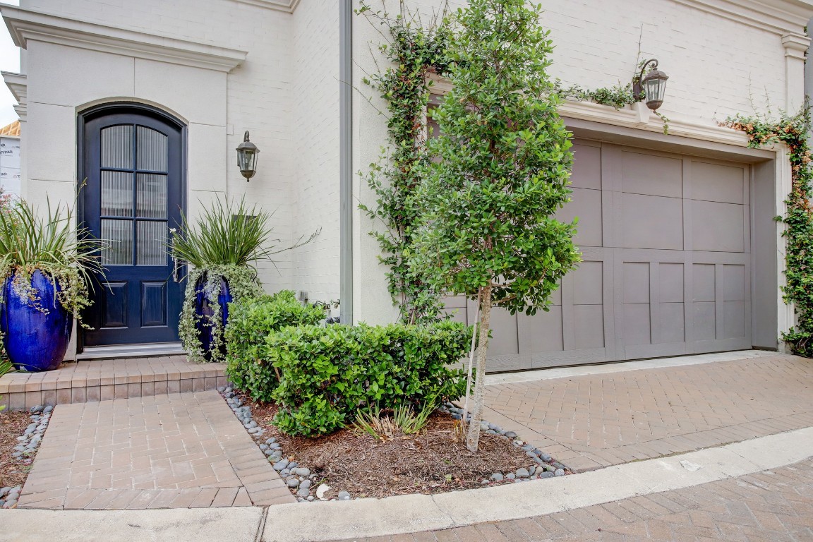 6103 Alexandra Grove Place Houston, TX 77055 - Photo 3 of 19 Front entrance surrounded by landscaping and an attached 2-car garage
