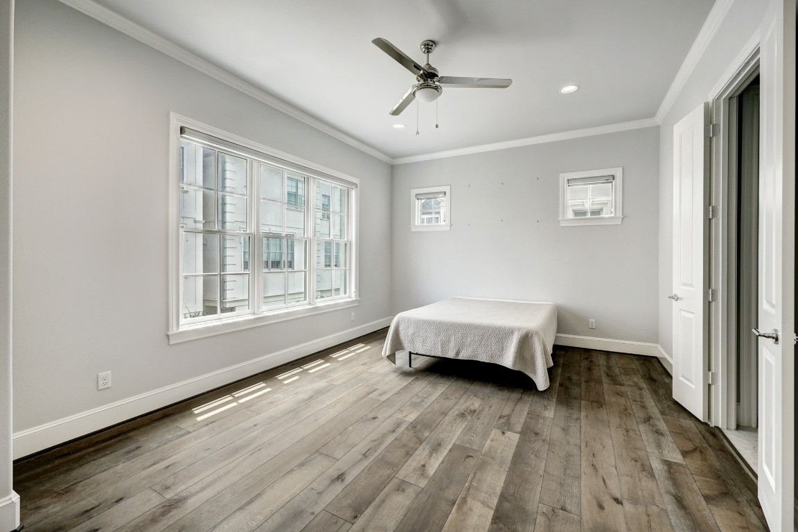 6103 Alexandra Grove Place Houston, TX 77055 - Photo 9 of 19 Second floor primary bedroom with 10'' ceilings, window shades and an en-suite bath