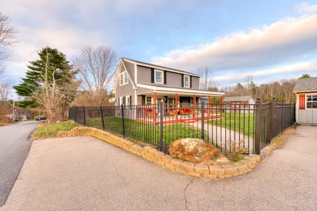 a view of a house with a wooden fence
