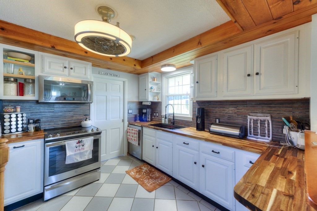 57 Carpenter Hill Road Charlton, MA 01507 - Photo 11 of 16 a kitchen with stainless steel appliances granite countertop a stove a sink and a white cabinets