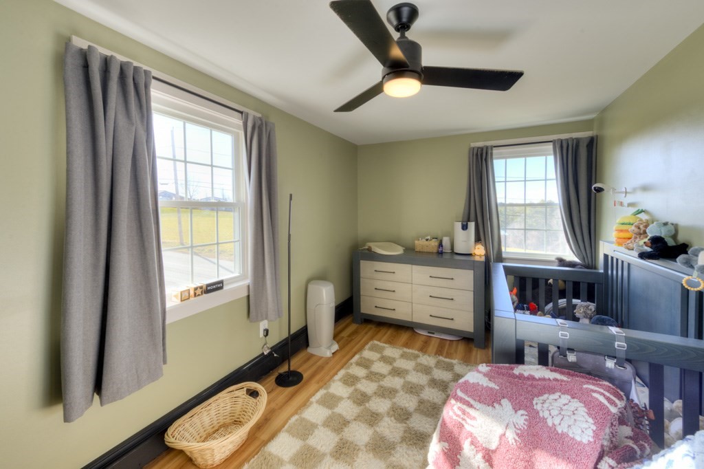 57 Carpenter Hill Road Charlton, MA 01507 - Photo 15 of 16 a bedroom with a bed and wooden floor