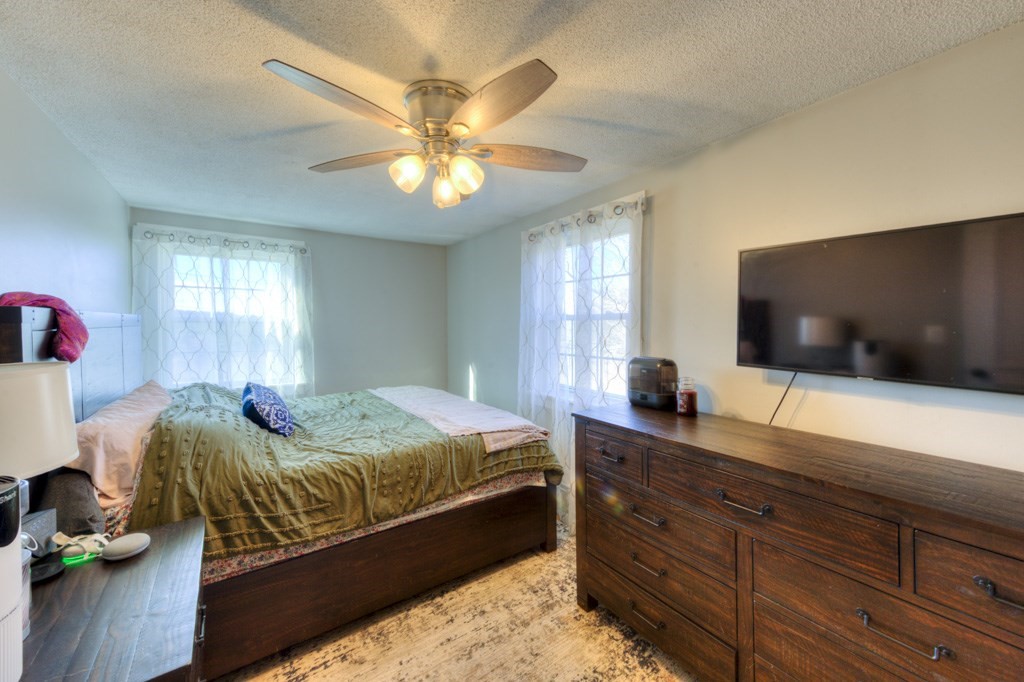 57 Carpenter Hill Road Charlton, MA 01507 - Photo 16 of 16 a bedroom with a large bed and a flat tv screen on dresser