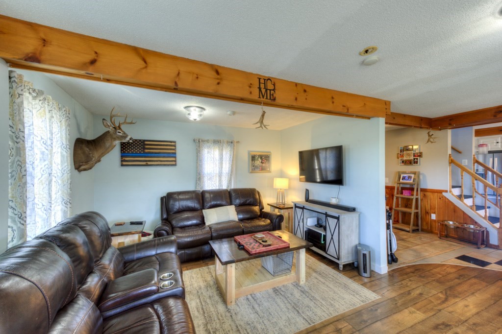 57 Carpenter Hill Road Charlton, MA 01507 - Photo 6 of 16 a living room with furniture a flat screen tv and a fireplace