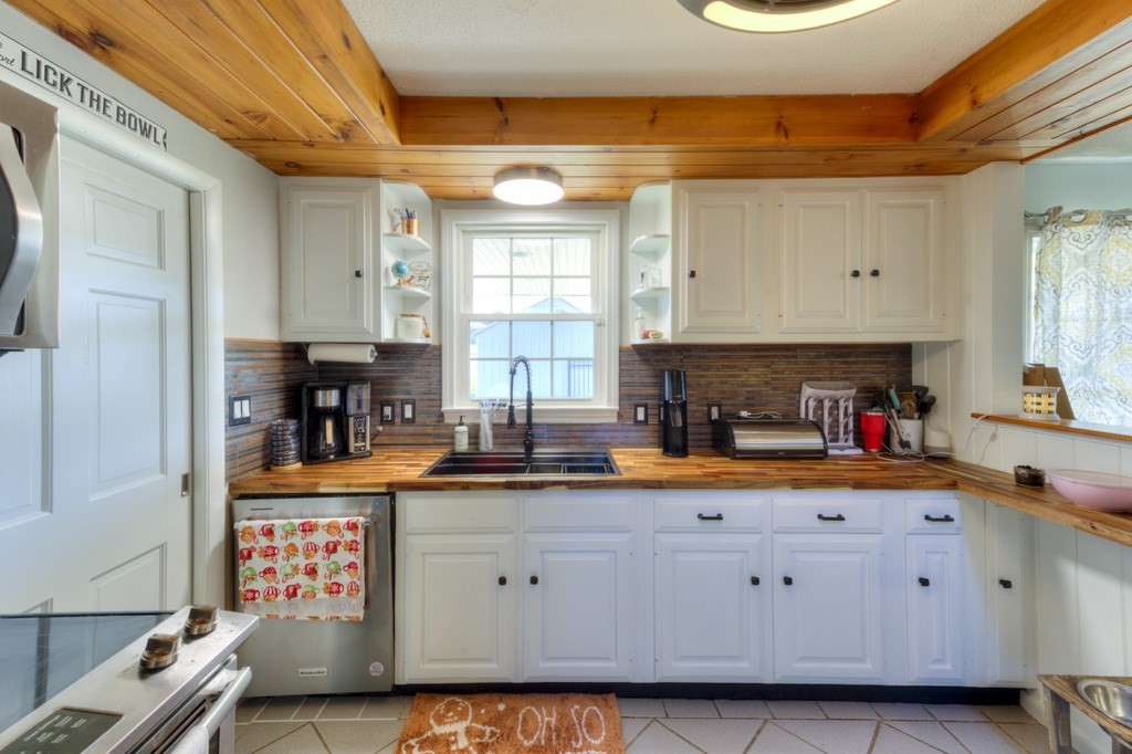 57 Carpenter Hill Road Charlton, MA 01507 - Photo 10 of 16 a kitchen with granite countertop a sink a stove and cabinets