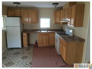 112 Matawan Road Old Bridge, NJ 08879 - Photo 1 of 1 a kitchen with stainless steel appliances granite countertop a refrigerator a stove a sink and a microwave