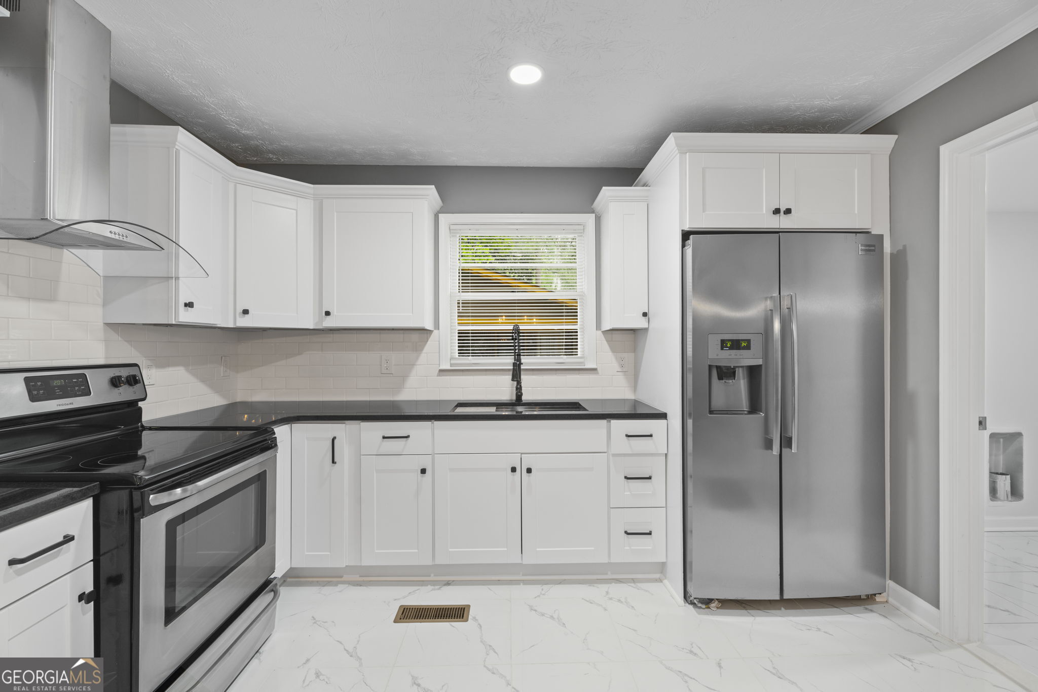 3567 Forrest Park Road Southeast Atlanta, GA 30354 - Photo 10 of 29 a kitchen with white cabinets and refrigerator