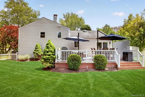 a view of a house with backyard and a sitting area