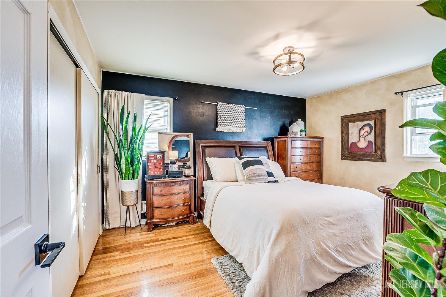 105 Madison Avenue Middlesex, NJ 08846 - Photo 11 of 27 a bedroom with a bed and a chandelier