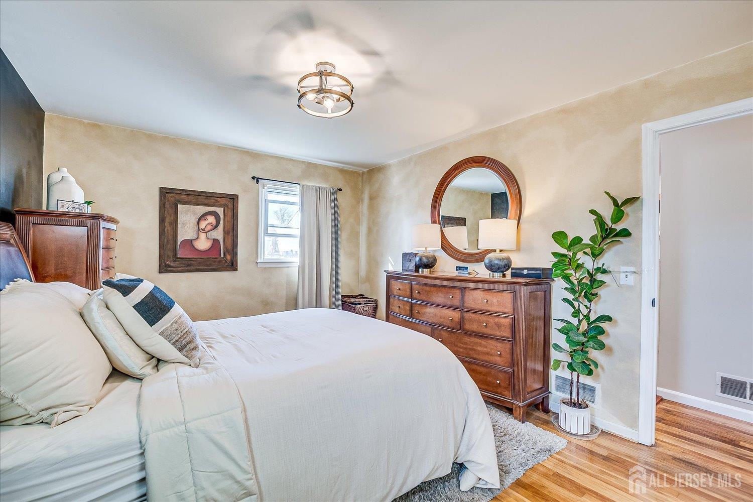 105 Madison Avenue Middlesex, NJ 08846 - Photo 12 of 27 a bedroom with a bed and a dresser with mirror