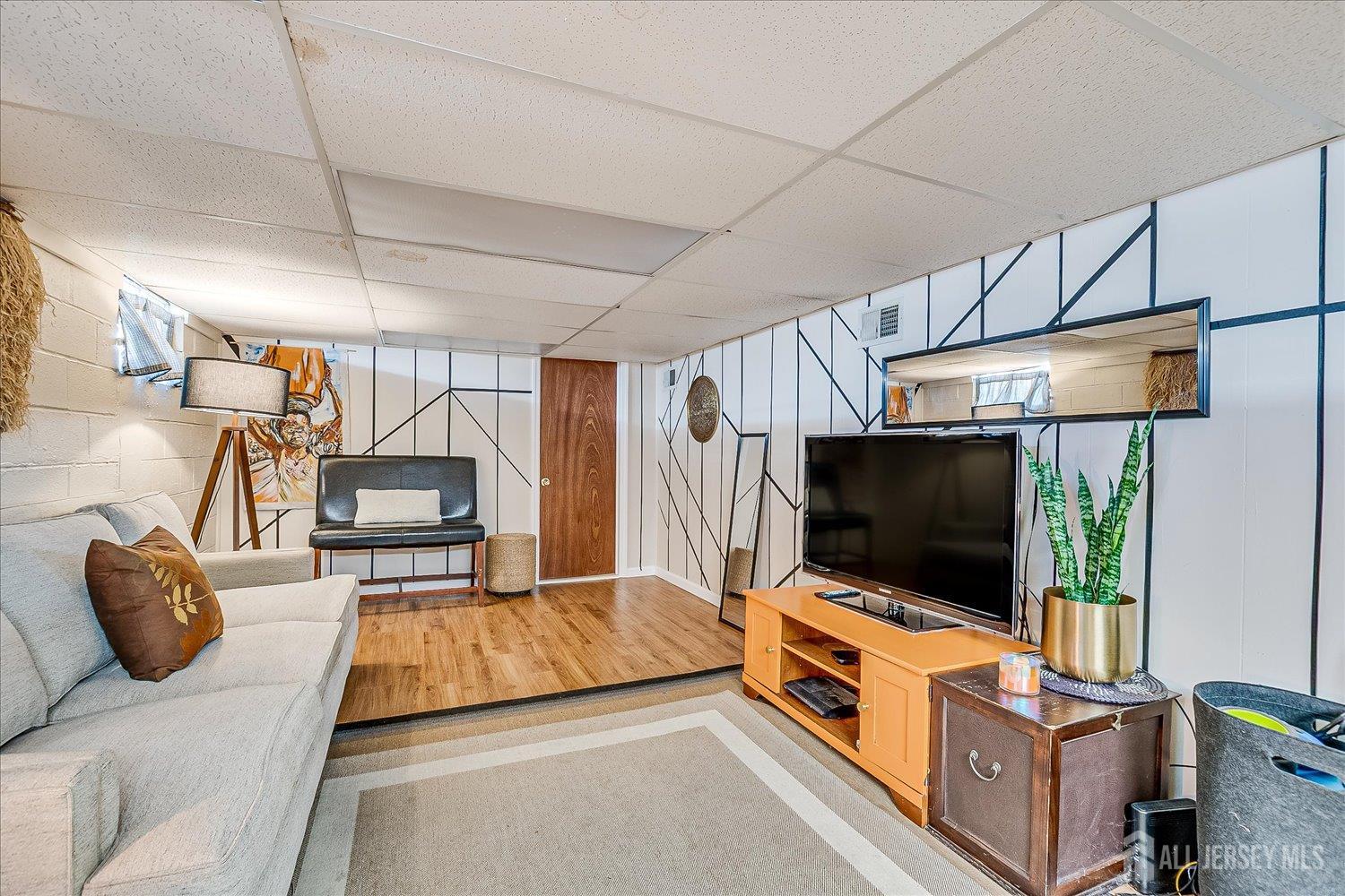 105 Madison Avenue Middlesex, NJ 08846 - Photo 19 of 27 a living room with furniture and a flat screen tv