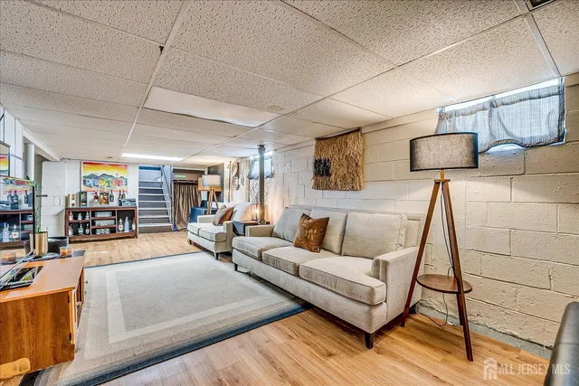 a living room with furniture and a lamp