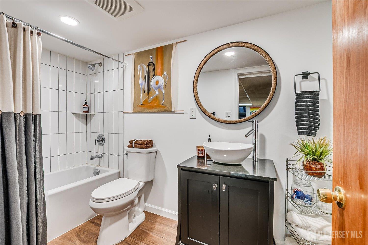 105 Madison Avenue Middlesex, NJ 08846 - Photo 21 of 27 a bathroom with a toilet a sink and a mirror
