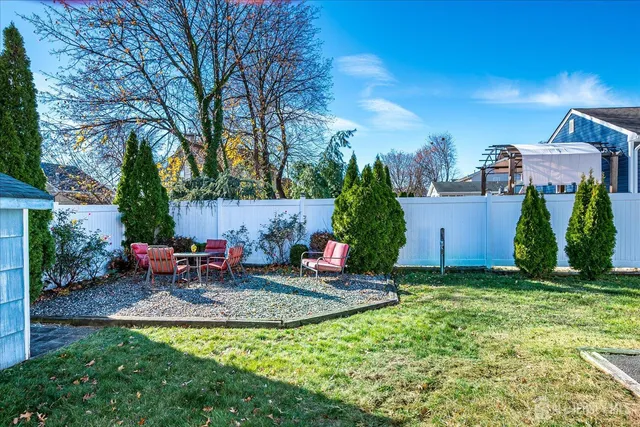 a view of a chairs and table in backyard of the house
