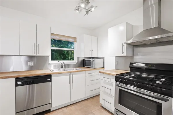 a kitchen with a sink stove and cabinets
