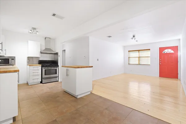 a view of a kitchen with microwave and cabinets