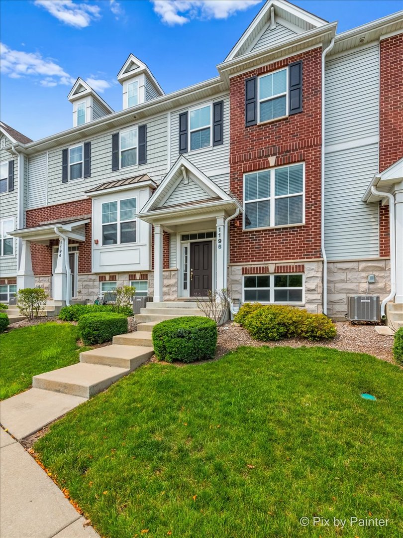 a front view of a house with a yard