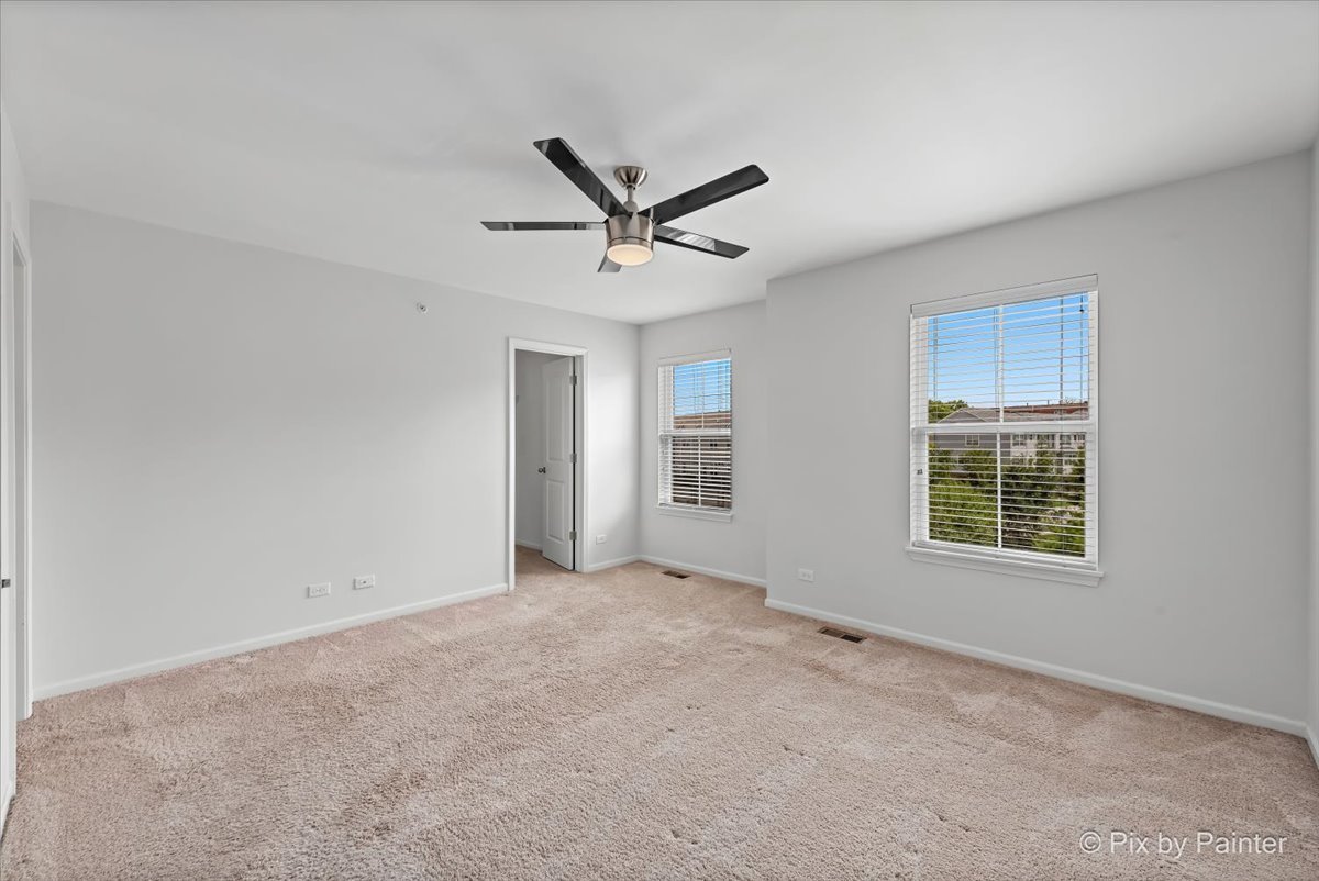 1196 Colfax Avenue Des Plaines, IL 60016 - Photo 11 of 28 a view of a livingroom with a ceiling fan and window