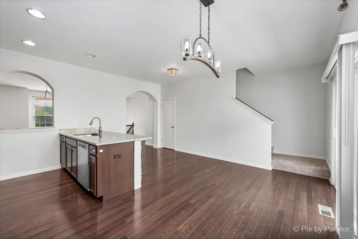 1196 Colfax Avenue Des Plaines, IL 60016 - Photo 7 of 28 a kitchen with stainless steel appliances granite countertop wooden floors and white walls