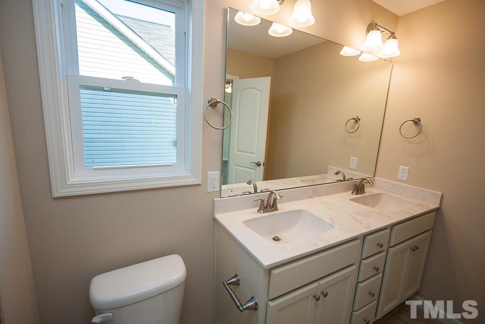 1856 Swepsonville Road Graham, NC 27253 - Photo 11 of 25 a bathroom with a sink a toilet and a mirror