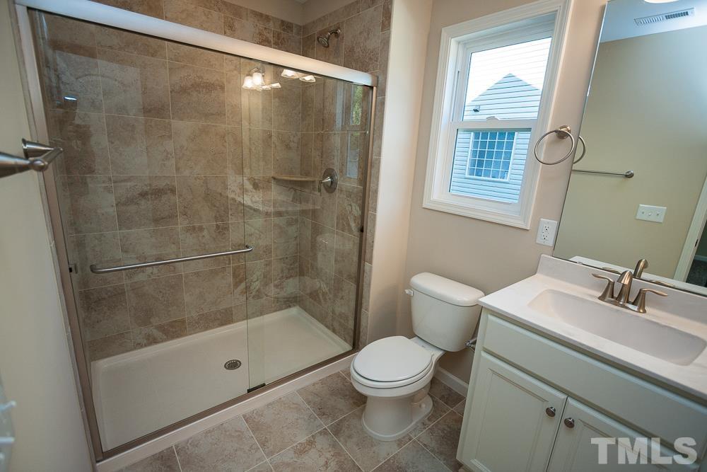 1856 Swepsonville Road Graham, NC 27253 - Photo 12 of 25 a bathroom with a shower a toilet and a sink