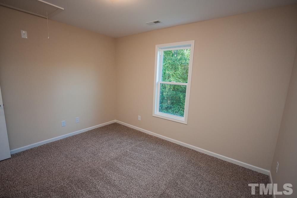 1856 Swepsonville Road Graham, NC 27253 - Photo 18 of 25 an empty room with a window
