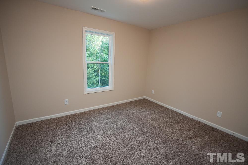 1856 Swepsonville Road Graham, NC 27253 - Photo 19 of 25 an empty room with a window