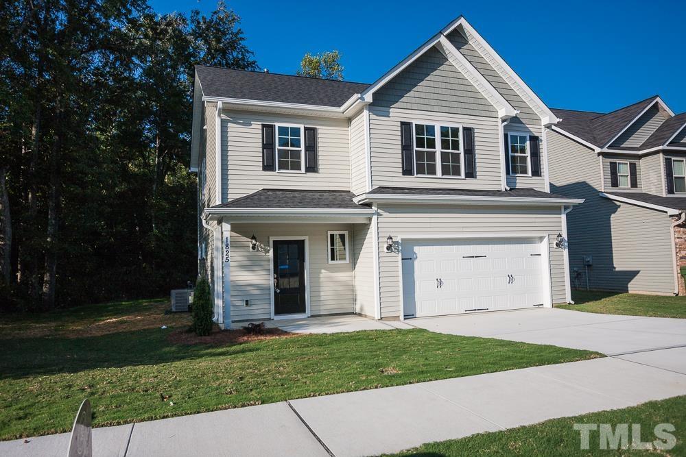 1856 Swepsonville Road Graham, NC 27253 - Photo 2 of 25 a view of a white house with a small yard and large trees