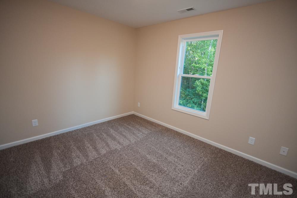1856 Swepsonville Road Graham, NC 27253 - Photo 21 of 25 an empty room with a window