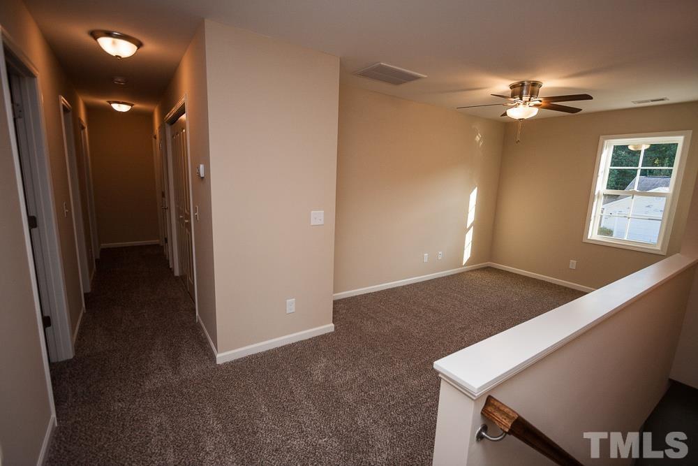 1856 Swepsonville Road Graham, NC 27253 - Photo 22 of 25 a view of a livingroom with a ceiling fan and window
