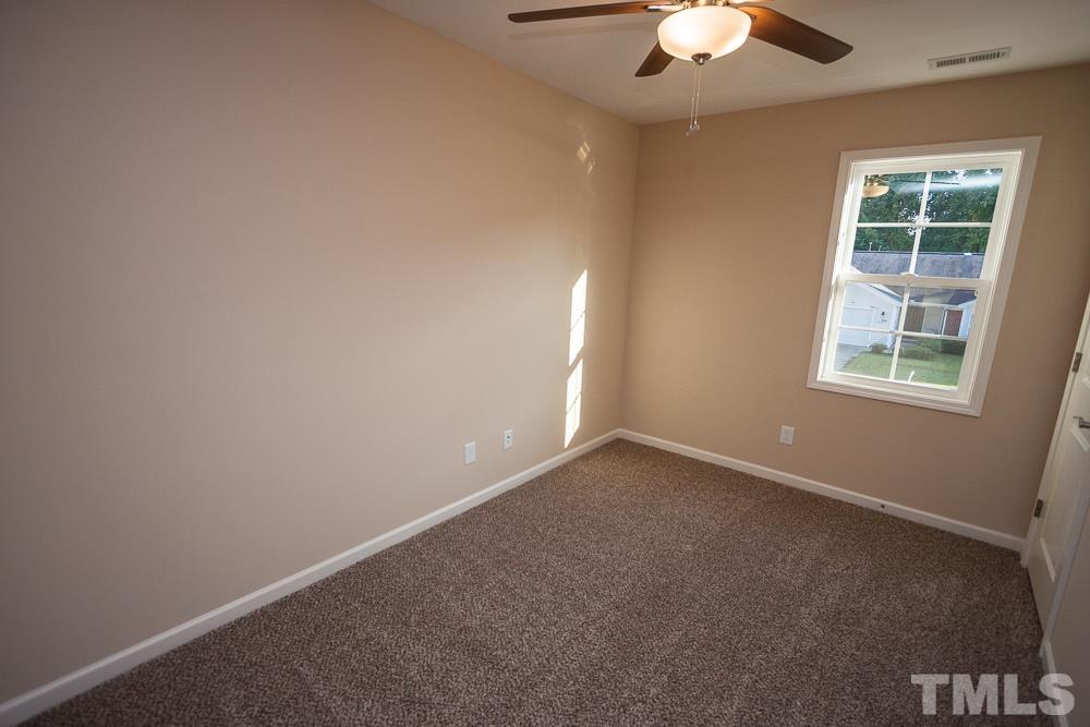 1856 Swepsonville Road Graham, NC 27253 - Photo 24 of 25 an empty room with a window and a fan