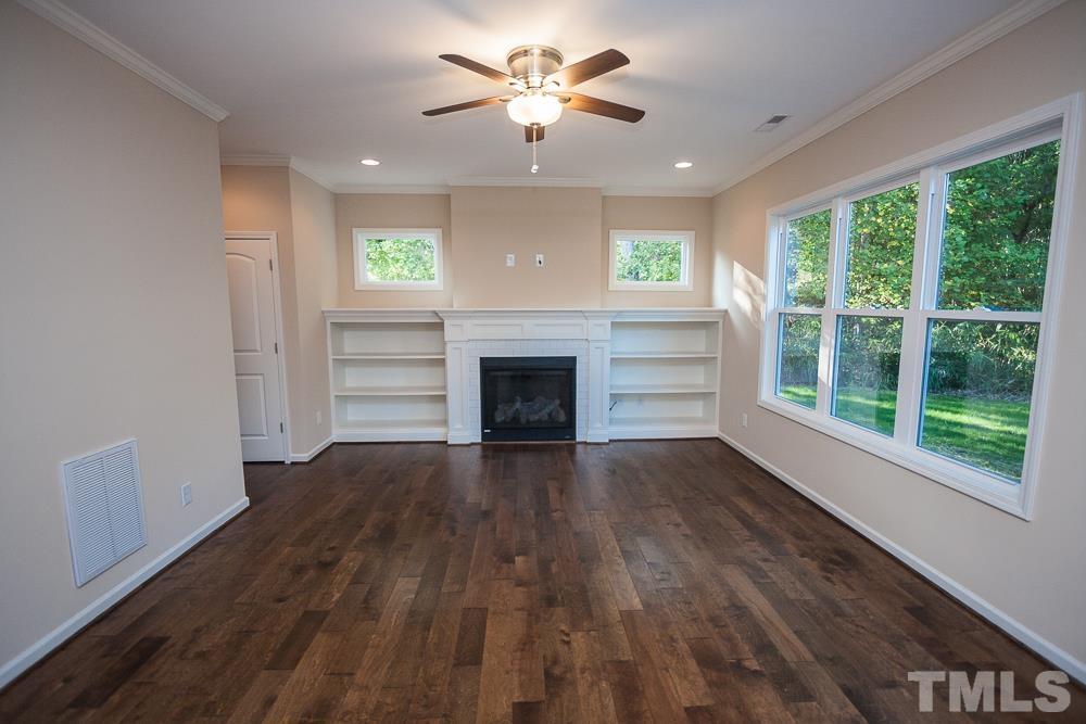 1856 Swepsonville Road Graham, NC 27253 - Photo 8 of 25 a view of an empty room with a window and wooden floor