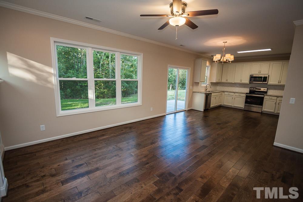 1856 Swepsonville Road Graham, NC 27253 - Photo 9 of 25 a view of kitchen with refrigerator stove and wooden floor