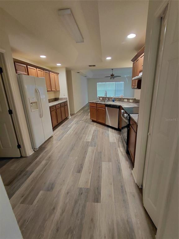 14295 Southwest 17th Place Ocala, FL 34481 - Photo 14 of 34 a view of kitchen with cabinets and wooden floor