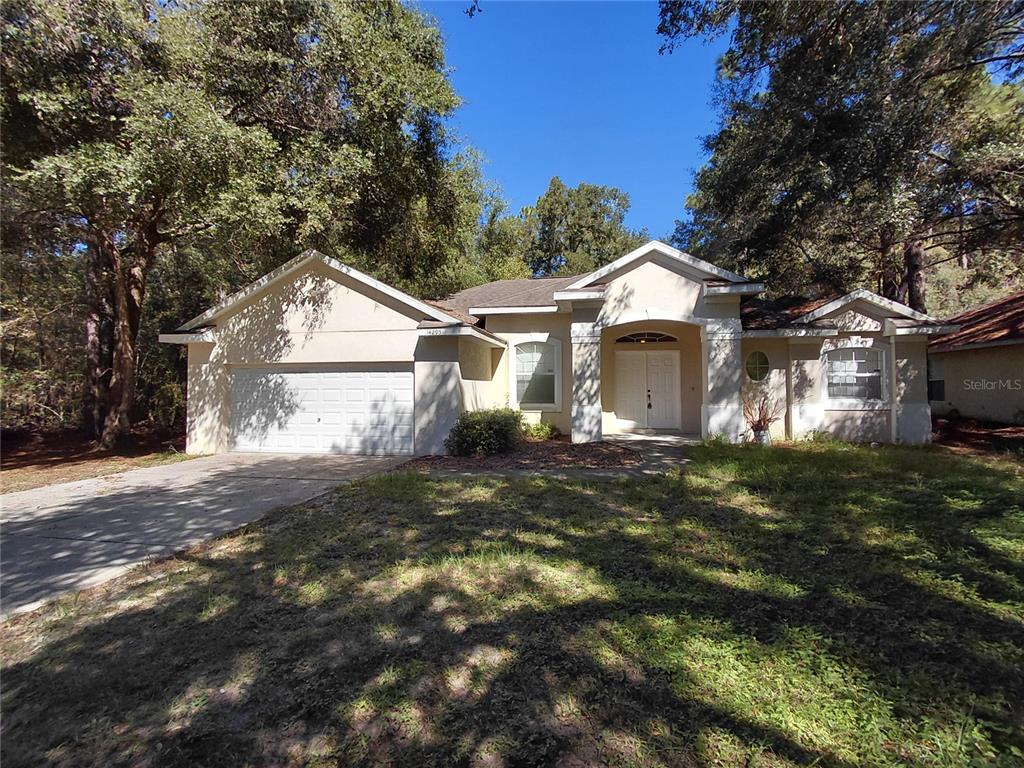 14295 Southwest 17th Place Ocala, FL 34481 - Photo 22 of 34 a front view of a house with a yard