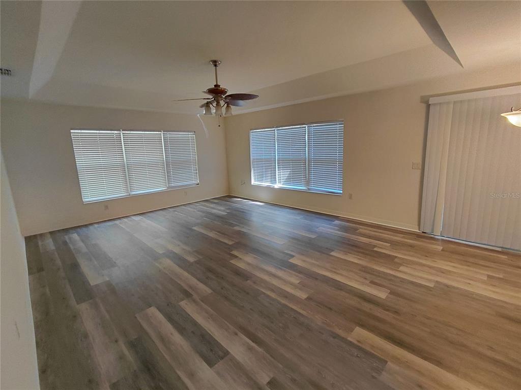14295 Southwest 17th Place Ocala, FL 34481 - Photo 3 of 34 a view of empty room with wooden floor and fan