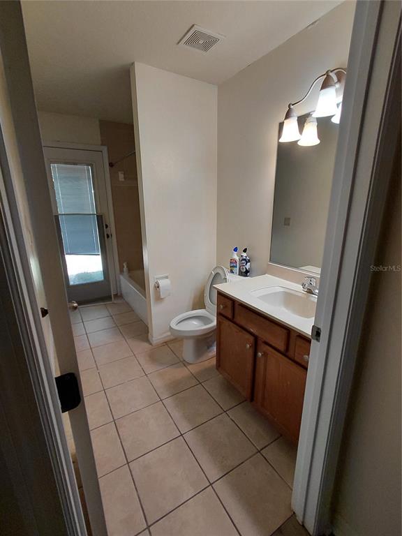14295 Southwest 17th Place Ocala, FL 34481 - Photo 31 of 34 a bathroom with a sink a toilet and a mirror
