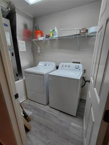 an empty room with a fireplace and windows