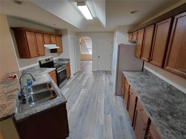 a kitchen with sink stove and cabinets
