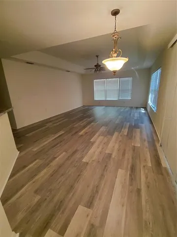 a view of a room with a ceiling fan window and a bathroom