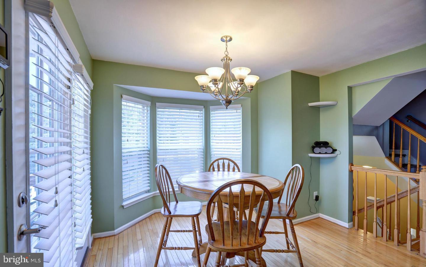 102 Cagney Terrace Southeast Leesburg, VA 20175 - Photo 11 of 26 a view of a dining room with furniture and a chandelier