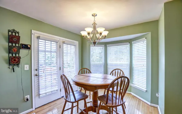 a view of a dining room with furniture and chandelier