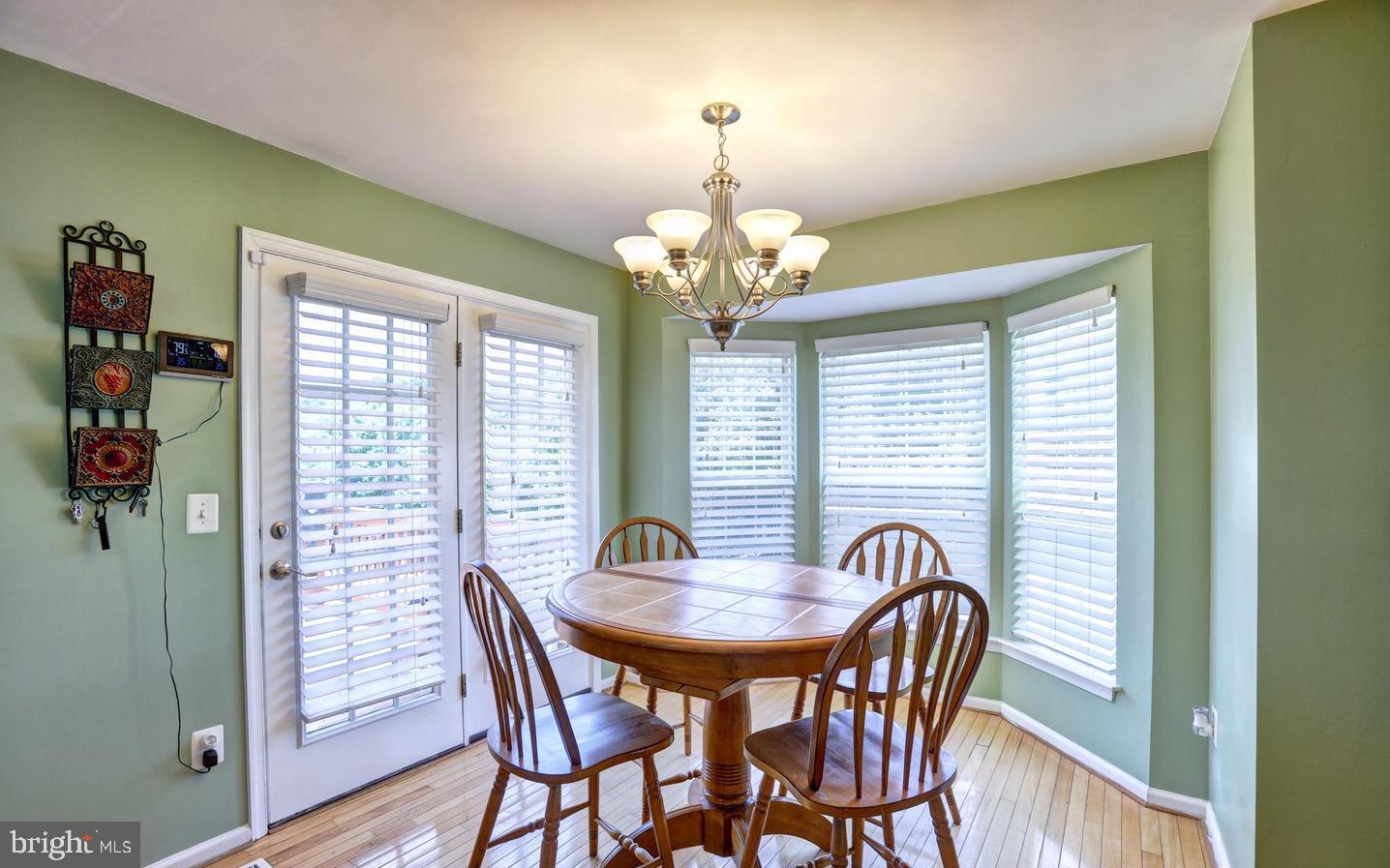 102 Cagney Terrace Southeast Leesburg, VA 20175 - Photo 12 of 26 a view of a dining room with furniture and chandelier