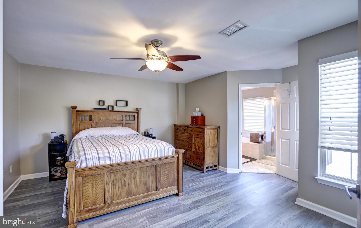 102 Cagney Terrace Southeast Leesburg, VA 20175 - Photo 16 of 26 a bedroom with a bed and wooden floor